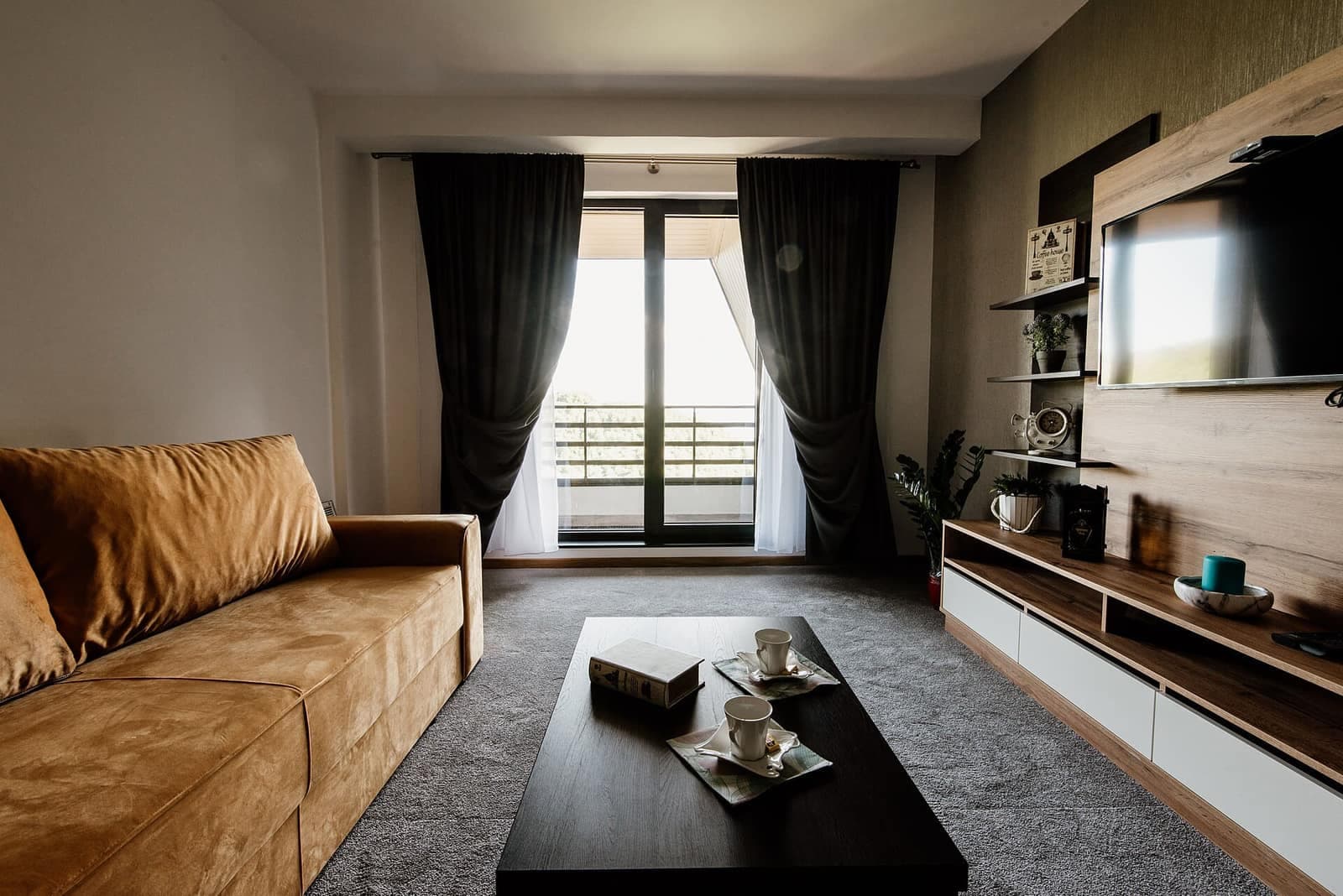 A bright living room with large windows onto the courtyard