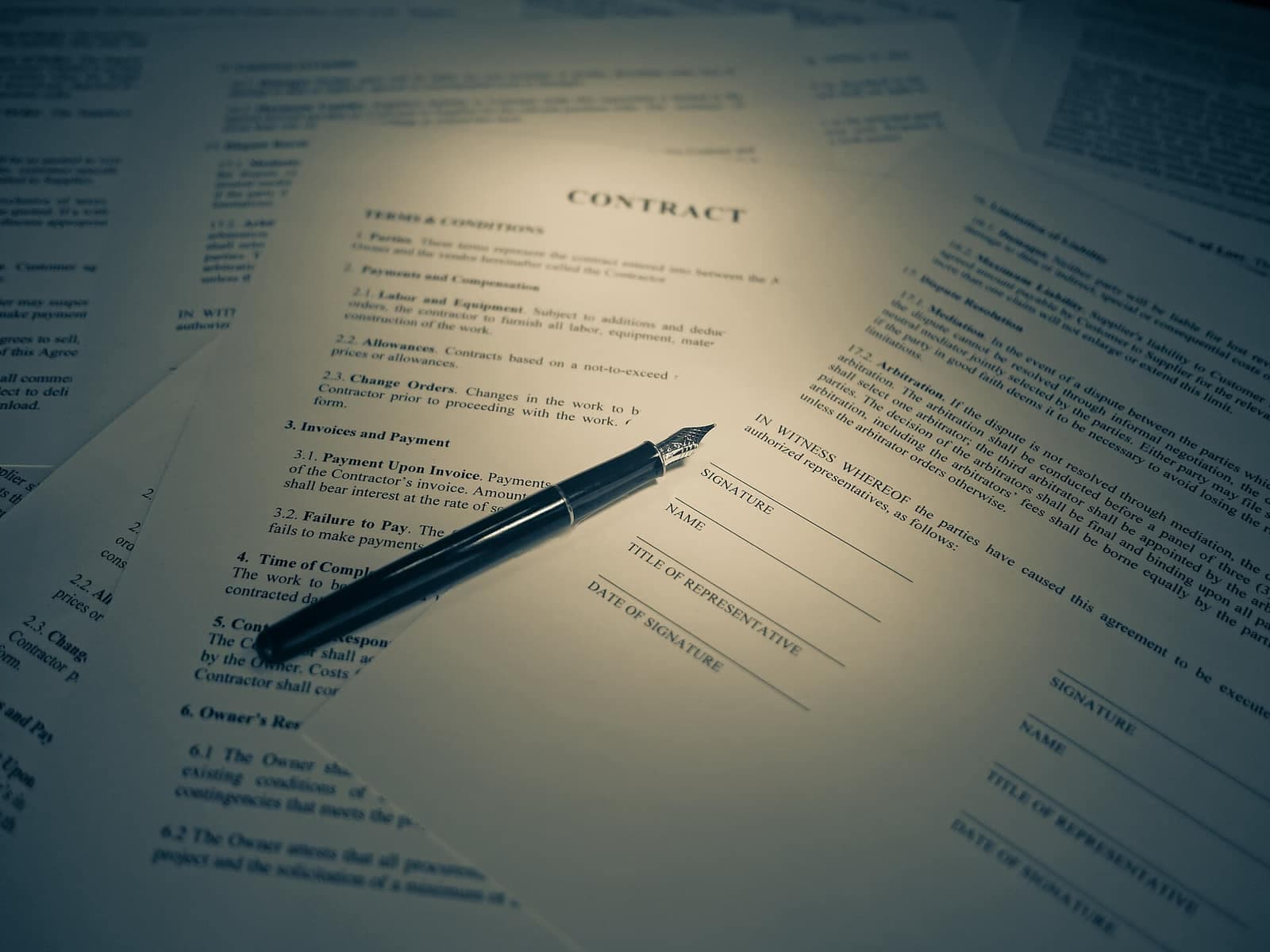 Purchase agreement papers and a fountain pen — the buyer's agent negotiates the terms